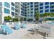 Spacious pool deck with numerous lounge chairs at 111 S Pineapple Ave # 708, Sarasota, FL 34236