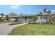 Charming light blue home with a covered porch and well-maintained lawn at 141 N Adams Dr, Sarasota, FL 34236