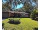 Brick ranch home with a well-maintained lawn and mature trees at 1507 Water Oak Way S, Bradenton, FL 34209