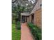 Pathway to covered entryway, surrounded by lush landscaping at 1507 Water Oak Way S, Bradenton, FL 34209