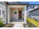 Inviting front porch with brown door and sidelights at 15093 Shady Palms Ln, Nokomis, FL 34275