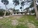 Ranch-style home with palm trees and a grassy yard at 175 Island Cir, Sarasota, FL 34242