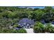 An aerial view of a stunning home with a large paved driveway at 2174 Mcclellan Pkwy, Sarasota, FL 34239