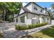 A paved walkway leads to a spacious backyard with lush landscaping and a pool at 2174 Mcclellan Pkwy, Sarasota, FL 34239
