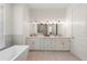 Modern bathroom with double vanity and bathtub at 2174 Mcclellan Pkwy, Sarasota, FL 34239