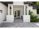 Front entrance with gray door, paver walkway, and white columns at 2174 Mcclellan Pkwy, Sarasota, FL 34239
