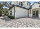 Two-car garage with white doors and paver driveway at 2174 Mcclellan Pkwy, Sarasota, FL 34239
