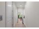 Bright hallway with light wood floors, leading to a dining area at 2174 Mcclellan Pkwy, Sarasota, FL 34239