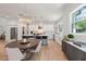 Open concept kitchen and dining area with modern finishes and hardwood floors at 2174 Mcclellan Pkwy, Sarasota, FL 34239