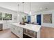Modern kitchen with white cabinets, quartz countertops, and stainless steel appliances at 2174 Mcclellan Pkwy, Sarasota, FL 34239
