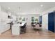 Modern kitchen with white cabinets, large island, and hardwood floors at 2174 Mcclellan Pkwy, Sarasota, FL 34239
