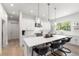 Eat-in kitchen with white cabinets, quartz countertops, and island seating at 2174 Mcclellan Pkwy, Sarasota, FL 34239