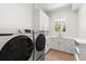 Modern laundry room with white cabinets, Samsung washer and dryer at 2174 Mcclellan Pkwy, Sarasota, FL 34239