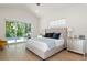 Main bedroom with plush bed, hardwood floors, and access to the pool at 2174 Mcclellan Pkwy, Sarasota, FL 34239