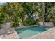 Relaxing rectangular pool surrounded by lush landscaping at 2174 Mcclellan Pkwy, Sarasota, FL 34239