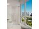 Modern bathroom with large window and walk-in shower at 223 Golden Gate Point # 2A, Sarasota, FL 34236