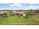 Home's back exterior, pool, and lush green yard at 2611 Little Country Rd, Parrish, FL 34219