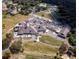 Aerial view of community clubhouse, golf course, tennis courts, and parking lot at 2611 Little Country Rd, Parrish, FL 34219