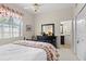 Bright bedroom with a queen-size bed and ensuite bathroom at 2611 Little Country Rd, Parrish, FL 34219