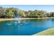 Serene fountain in a community lake, surrounded by lush greenery at 2611 Little Country Rd, Parrish, FL 34219