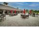 Outdoor patio with wicker furniture and red umbrellas at 2611 Little Country Rd, Parrish, FL 34219