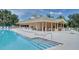 Community pool with clubhouse and lounge chairs at 2611 Little Country Rd, Parrish, FL 34219