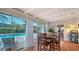 Dining area with wood floors and sliding glass doors to a pool view at 2651 Leafy Ln, Sarasota, FL 34239