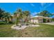 Landscaped yard with tropical plants and white rock at 337 Dante Dr # 337, Nokomis, FL 34275