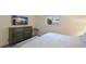Bedroom with king bed, dresser, and TV at 3751 S School Ave # 11, Sarasota, FL 34239