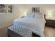 King bedroom with tufted bench and wood floors at 3751 S School Ave # 11, Sarasota, FL 34239