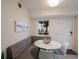 Small dining area with round table and built-in banquette seating at 3751 S School Ave # 11, Sarasota, FL 34239