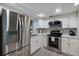 Modern kitchen with stainless steel appliances and white cabinets at 3751 S School Ave # 11, Sarasota, FL 34239