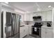 Modern kitchen with stainless steel appliances and white cabinets at 3751 S School Ave # 11, Sarasota, FL 34239
