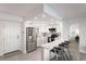 Modern white kitchen with stainless steel appliances and breakfast bar at 3751 S School Ave # 11, Sarasota, FL 34239