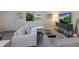 Bright living room features a sectional sofa, large TV, and wood-look floors at 3751 S School Ave # 11, Sarasota, FL 34239