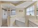 Bathroom features a shower and corner bathtub at 3915 Fonsica Ave, North Port, FL 34286
