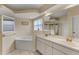 Bathroom with double vanity, corner tub, and separate shower at 3915 Fonsica Ave, North Port, FL 34286