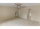 Bedroom with tile floors, ceiling fan, and access to bathroom at 3915 Fonsica Ave, North Port, FL 34286
