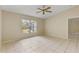 Bedroom with large window, tile floors and ceiling fan at 3915 Fonsica Ave, North Port, FL 34286