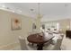 Dining room with a staged table and chandelier, leading to the living room at 3915 Fonsica Ave, North Port, FL 34286