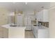 White kitchen with ample counter space and a tile backsplash at 3915 Fonsica Ave, North Port, FL 34286