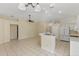 Kitchen boasts white appliances, an island, and tile flooring throughout at 3915 Fonsica Ave, North Port, FL 34286