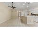 Bright kitchen features white cabinetry, tile flooring, and a breakfast bar at 3915 Fonsica Ave, North Port, FL 34286