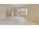 Living room with tile floors and bay window, looking toward entryway at 3915 Fonsica Ave, North Port, FL 34286