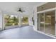 Spacious screened porch with ceiling fan and view of backyard at 3915 Fonsica Ave, North Port, FL 34286