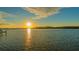 Stunning sunset over calm water with a dock at 3920 Red Rock Way, Sarasota, FL 34231