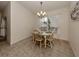 Bright dining area with table and chairs, chandelier, and decorative wall art at 4352 Adelaide Ave, North Port, FL 34288