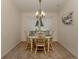 Bright dining area with table and chairs, chandelier, and decorative wall art at 4352 Adelaide Ave, North Port, FL 34288