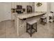 Kitchen island with granite countertop and two gray stools at 4352 Adelaide Ave, North Port, FL 34288