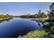 Serene lake view with dock and lush vegetation at 4352 Adelaide Ave, North Port, FL 34288
